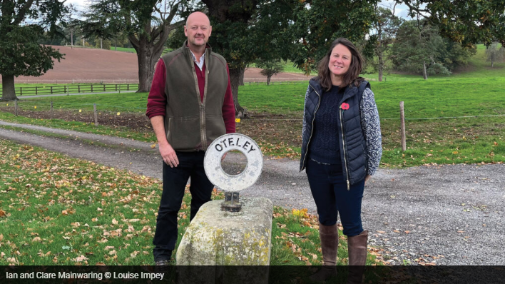 Farmers at the front of their estate sign