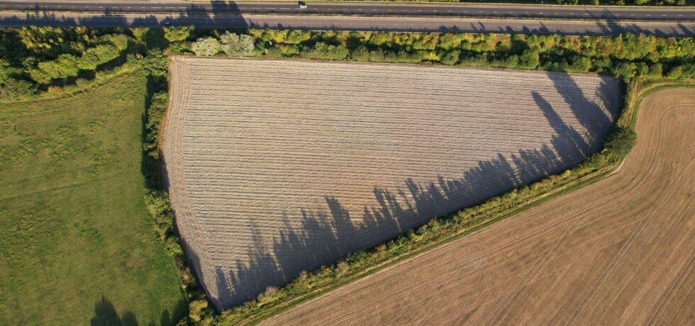 aerial image of agricultural field with main road to the right