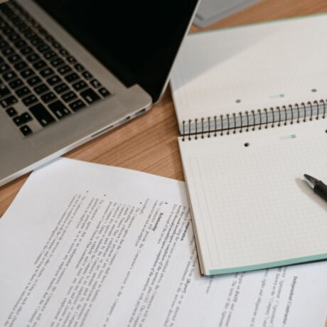 paper, laptop and documents on desk