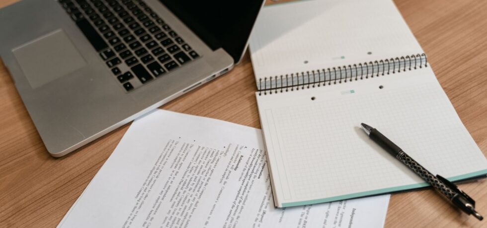 paper, laptop and documents on desk