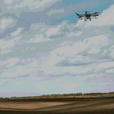 Image of a drone flying over a field