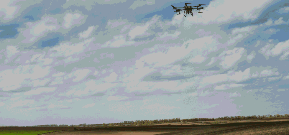 Image of a drone flying over a field